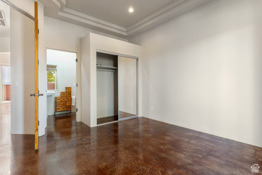 Unfurnished bedroom with a closet, recessed lighting, concrete floors, and visible vents