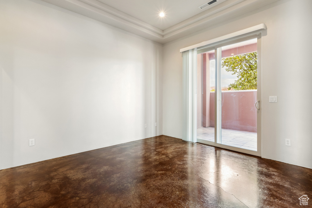 Unfurnished room featuring concrete floors and visible vents