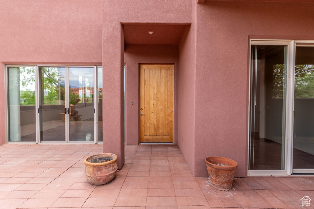 Property entrance featuring a patio and stucco siding