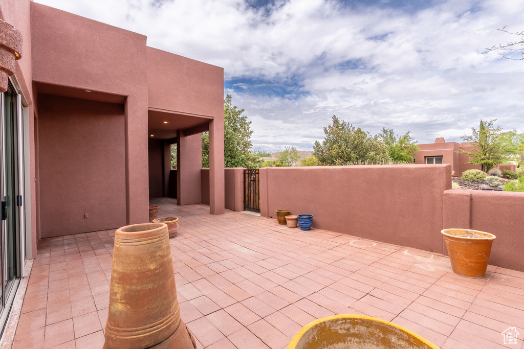 View of patio with a gate