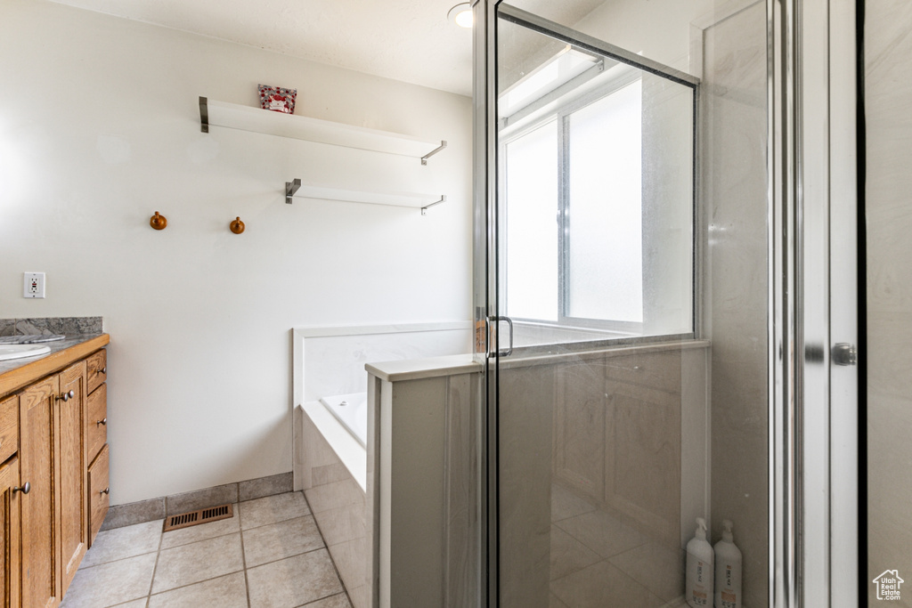 Bathroom with a garden tub, tile patterned floors, a stall shower, vanity, and visible vents