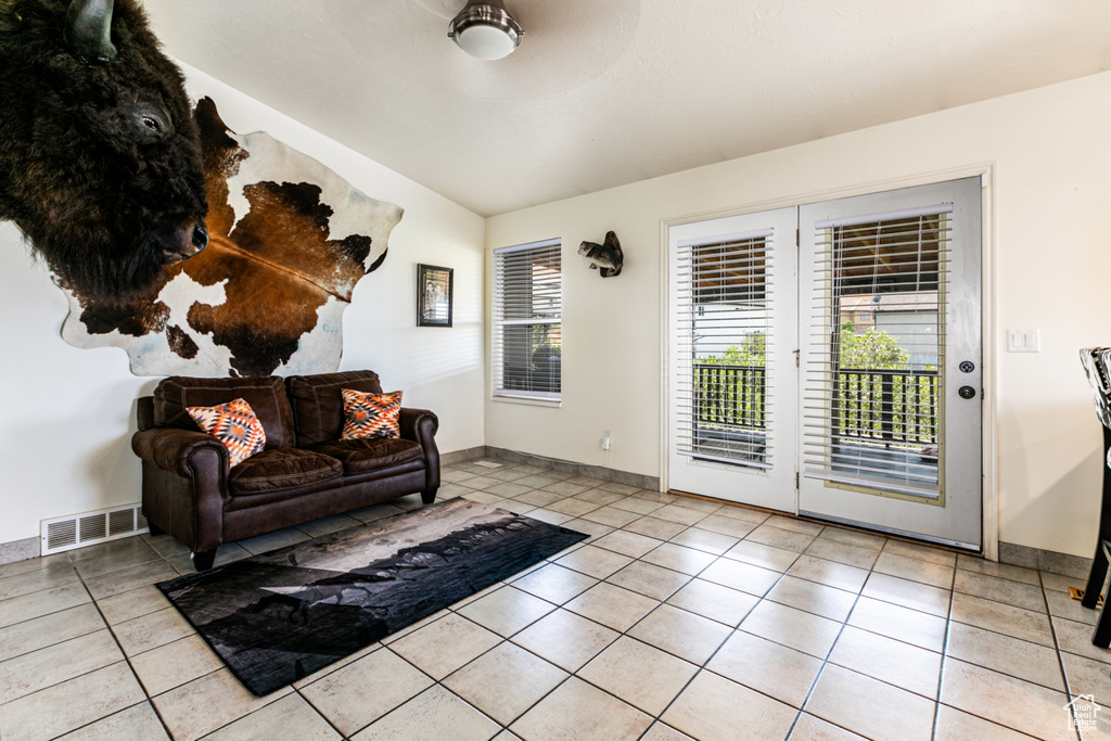 Living room featuring baseboards, visible vents, and light tile patterned floors