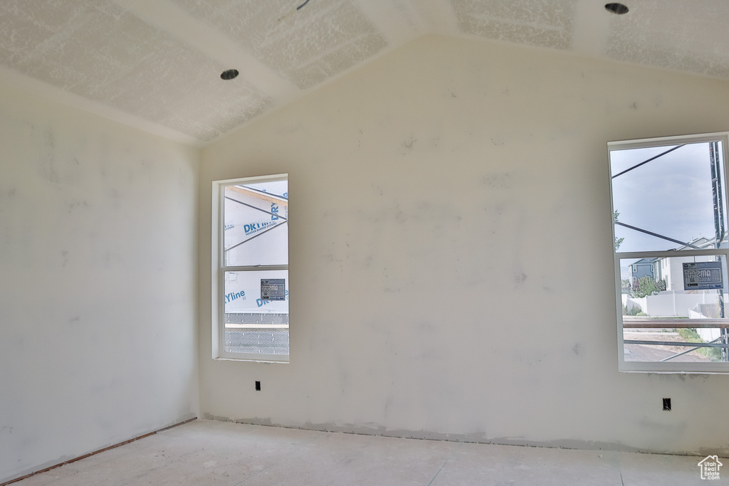 Unfurnished room with vaulted ceiling and plenty of natural light