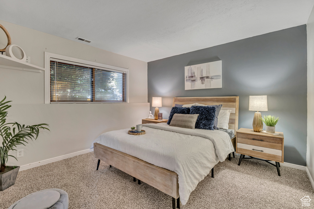 Carpeted bedroom featuring baseboards