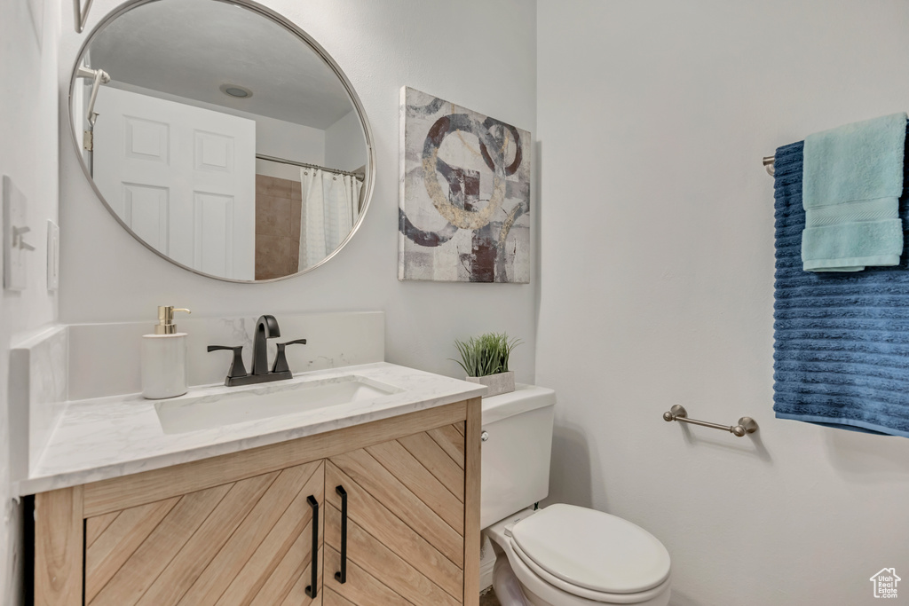 Full bathroom with vanity and toilet