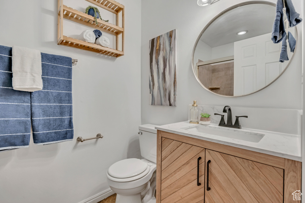 Full bathroom with vanity, toilet, and a shower