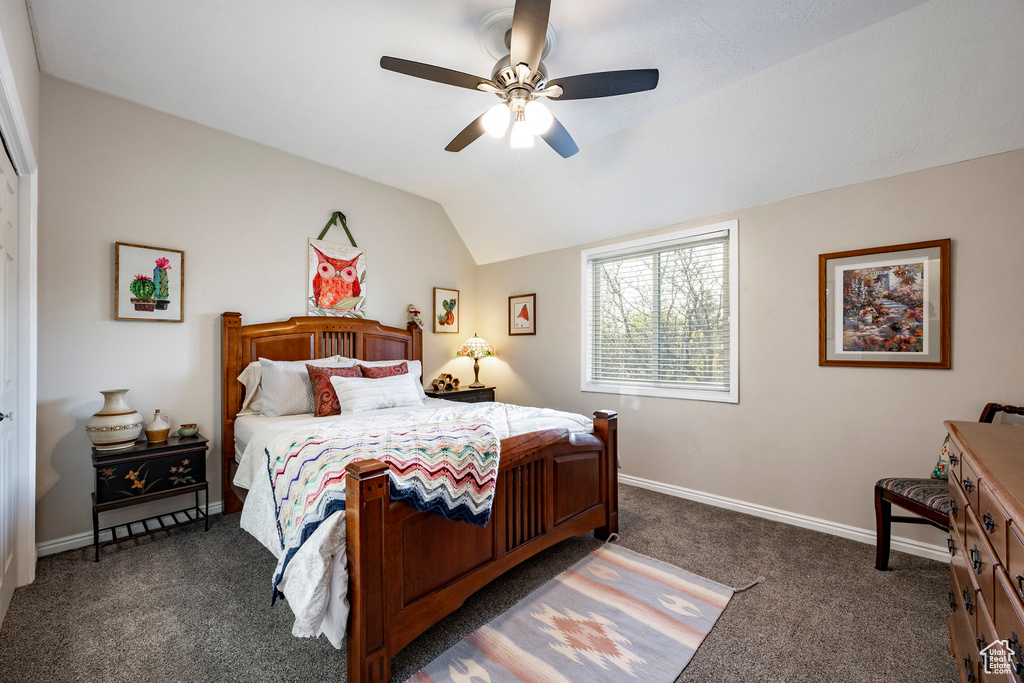 Bedroom featuring baseboards, lofted ceiling, a ceiling fan, and carpet floors