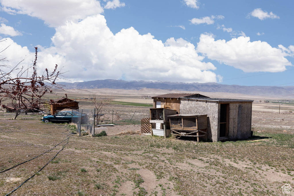 View of poultry coop featuring a mountain view, fence, and a rural view