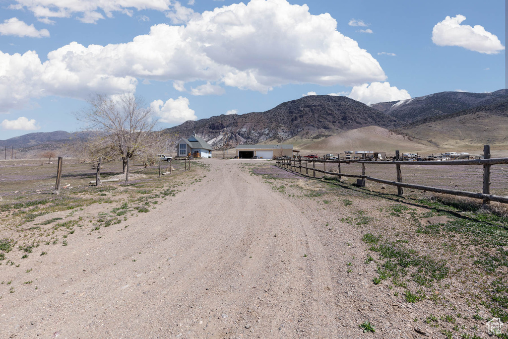View of street featuring a mountain view, a rural view, and driveway