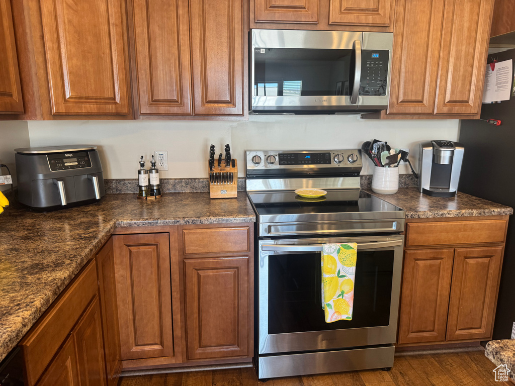 Kitchen featuring stainless steel appliances and brown cabinets