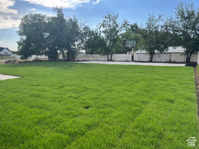 View of yard featuring basketball court