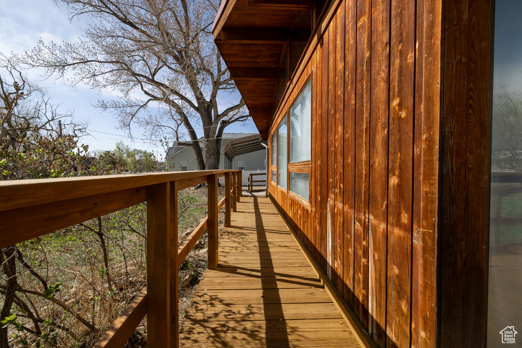 View of home\'s exterior with a wooden deck and board and batten siding