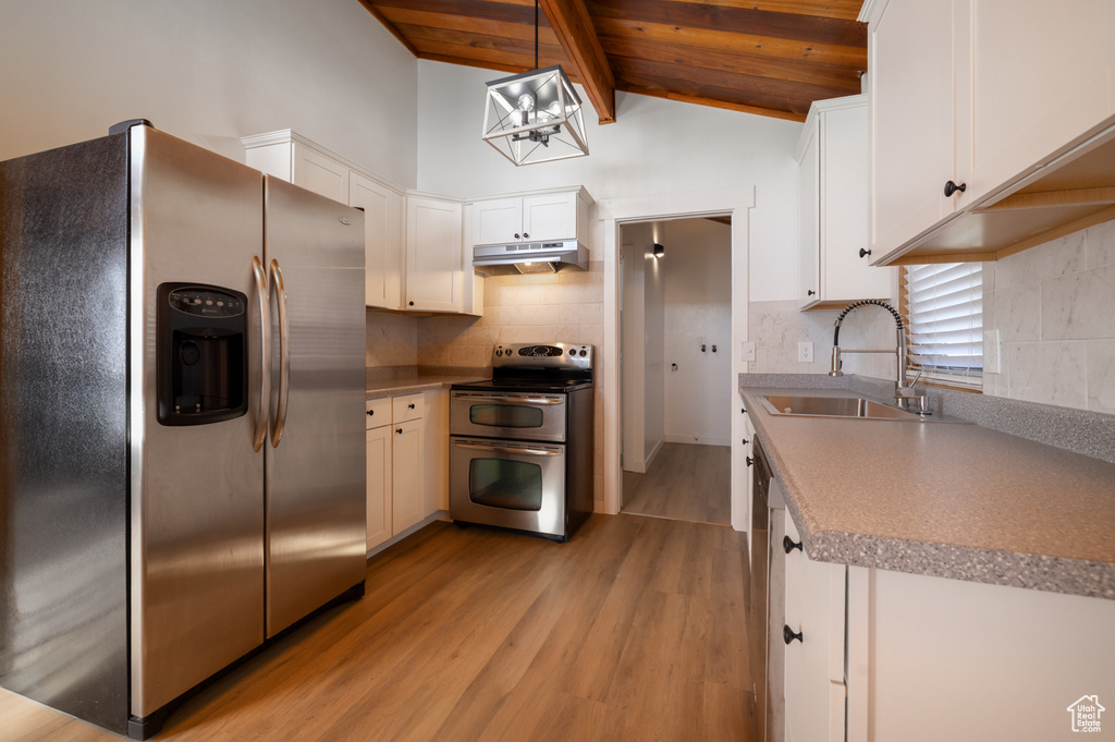 Kitchen featuring a sink, wood ceiling, appliances with stainless steel finishes, light wood-style flooring, and under cabinet range hood