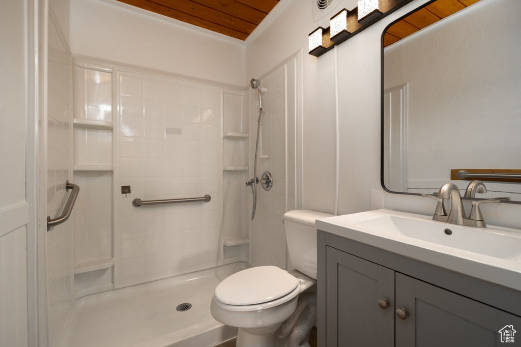 Full bathroom with wood ceiling, toilet, vanity, and a shower