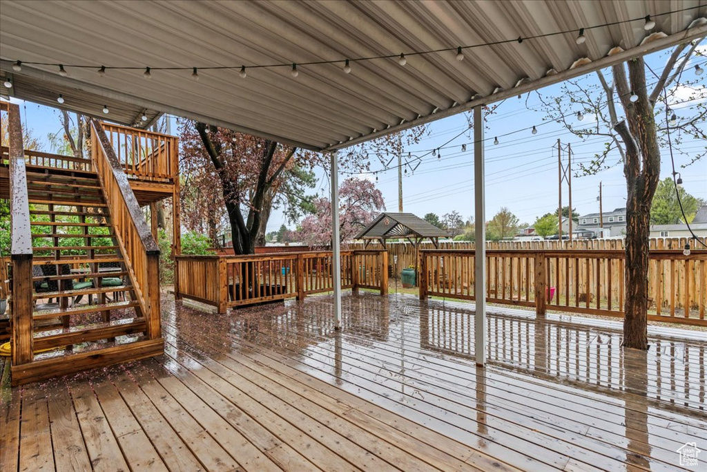 Deck featuring a fenced backyard and stairs