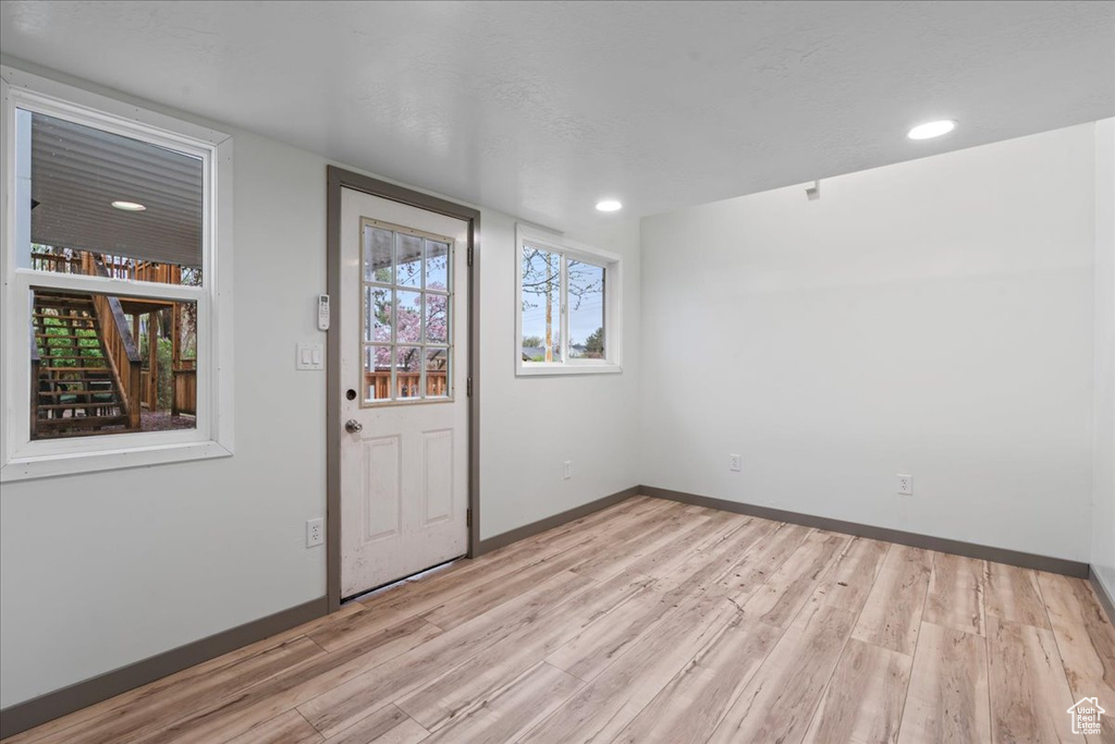 Entrance foyer featuring light wood-type flooring, baseboards, and recessed lighting