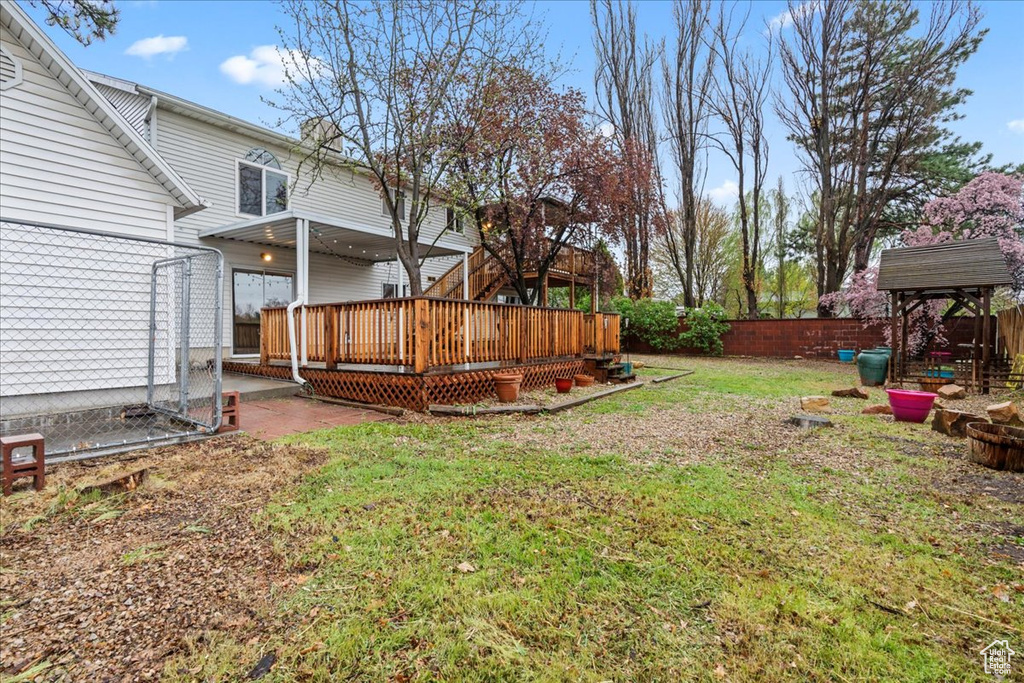 View of yard featuring a wooden deck and a fenced backyard