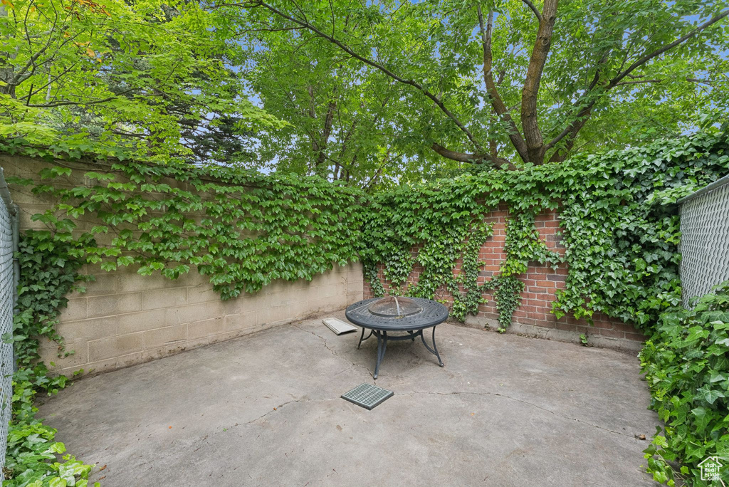 Fenced backyard with a fire pit and a patio area