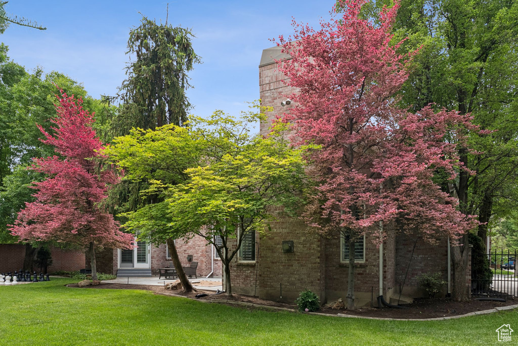 Rear view of property featuring brick siding and a patio