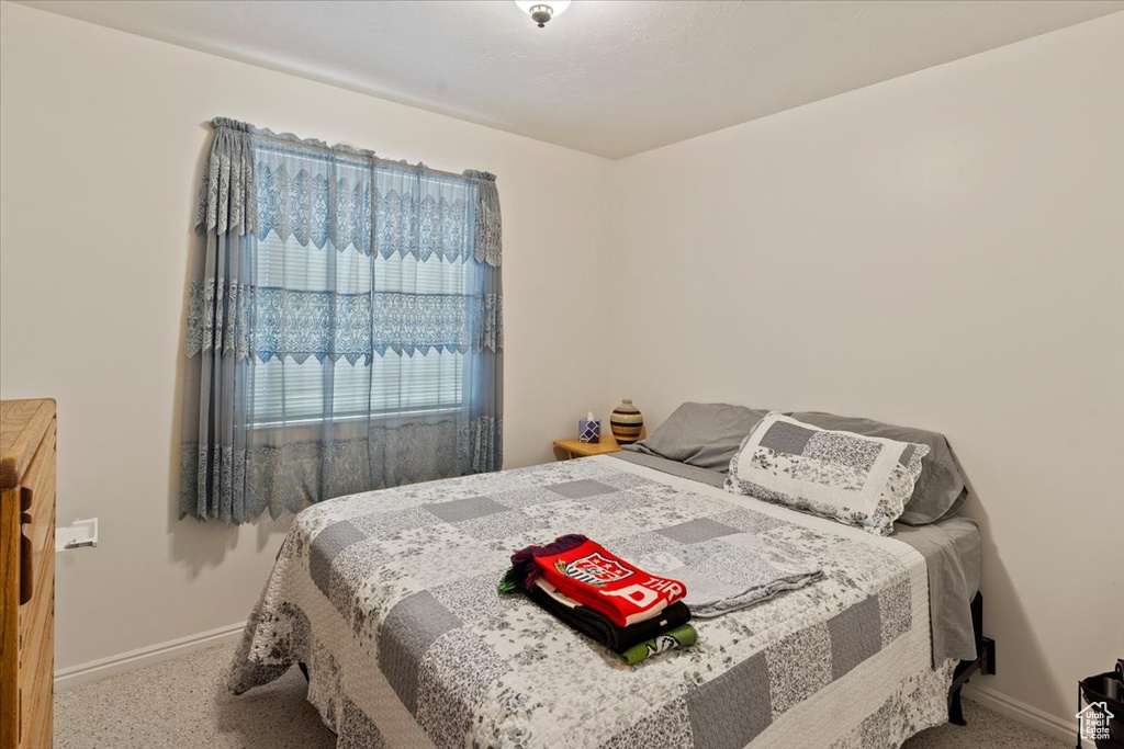 Carpeted bedroom featuring baseboards
