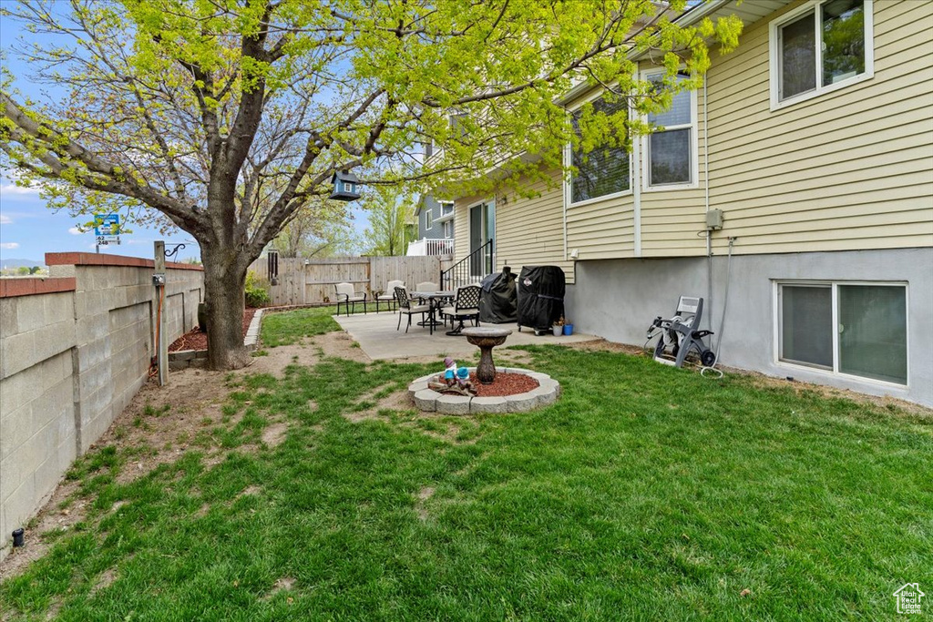 View of yard with a fenced backyard and a patio