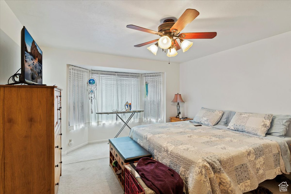 Bedroom featuring baseboards, carpet, and ceiling fan