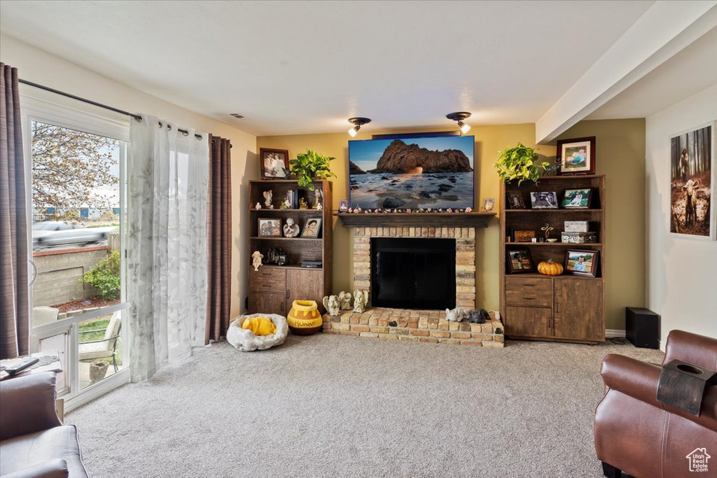 Carpeted living room featuring a fireplace