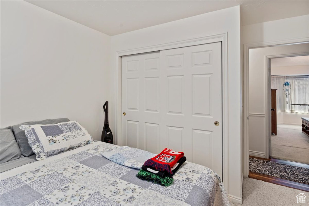 Bedroom with carpet floors, a closet, and baseboards