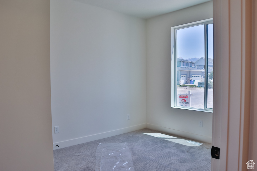 Empty room with carpet floors and baseboards