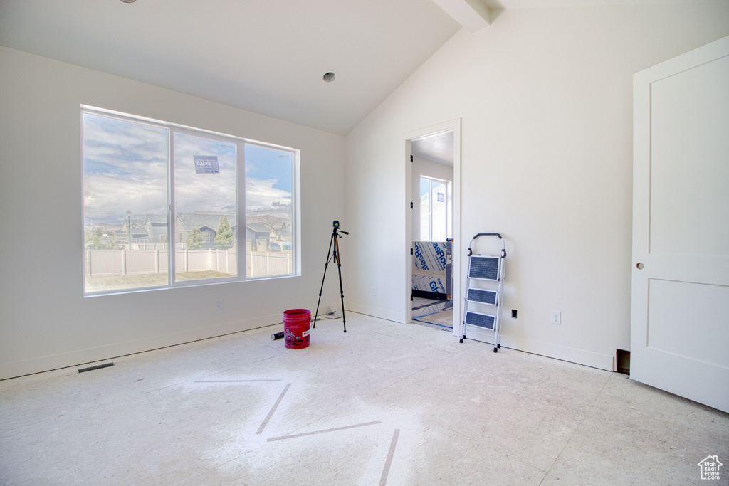 Recreation room with baseboards, high vaulted ceiling, and beam ceiling