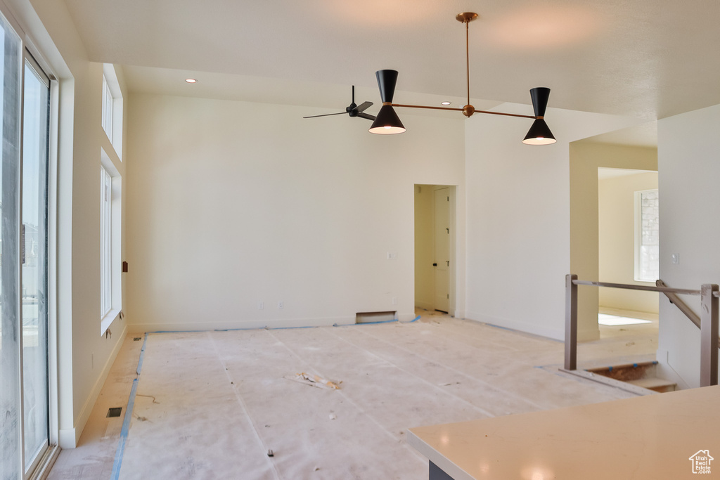 Unfurnished room with a high ceiling, baseboards, a ceiling fan, and recessed lighting