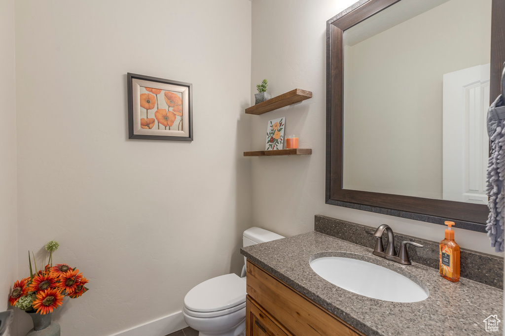 Half bathroom with toilet and vanity