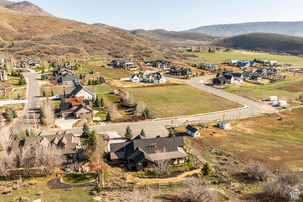 Aerial view of property's location with a mountain backdrop and nearby suburban area