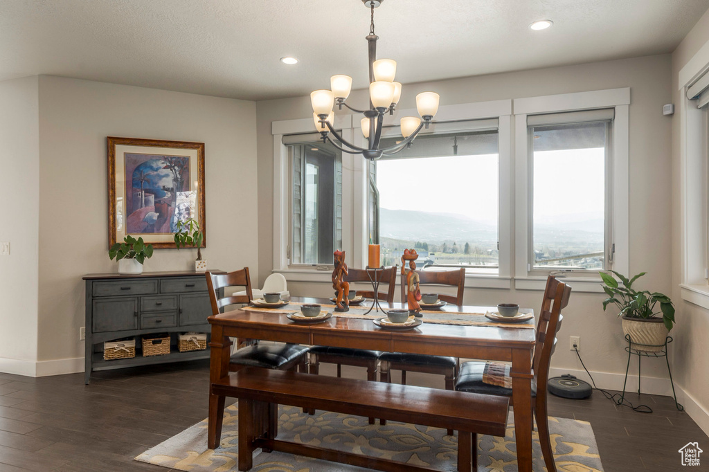 Dining space featuring wood finished floors, a chandelier, baseboards, and recessed lighting