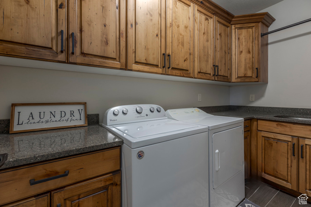 Laundry room featuring washing machine and dryer and cabinet space