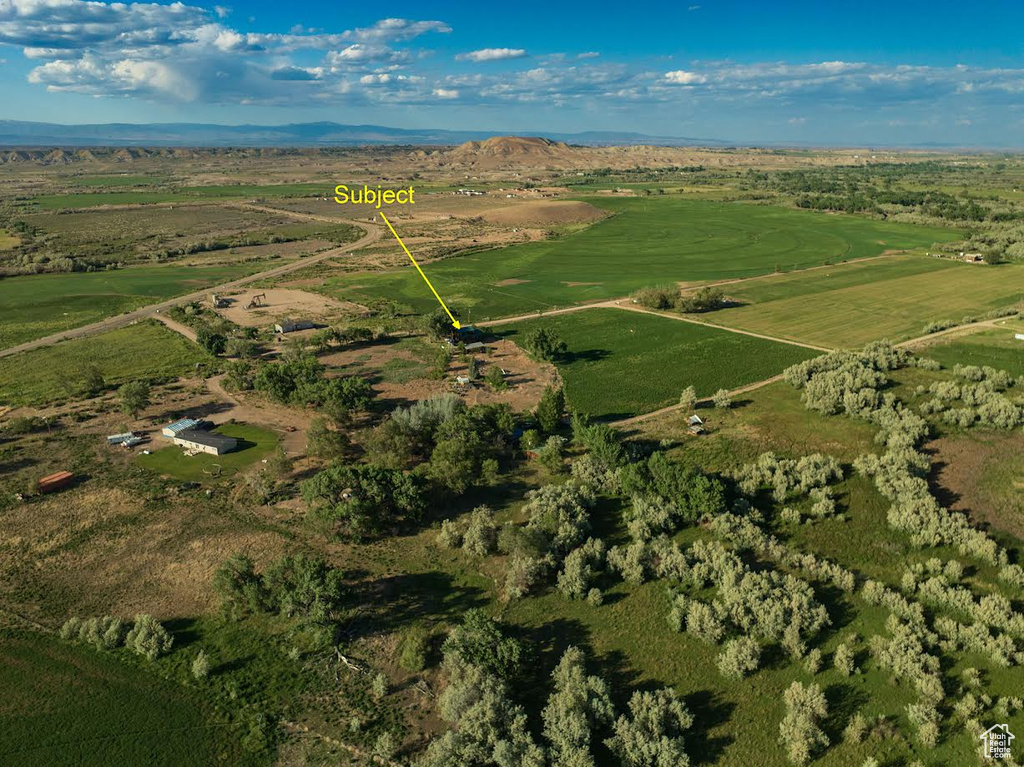 Aerial view of property and surrounding area with rural landscape and mountains