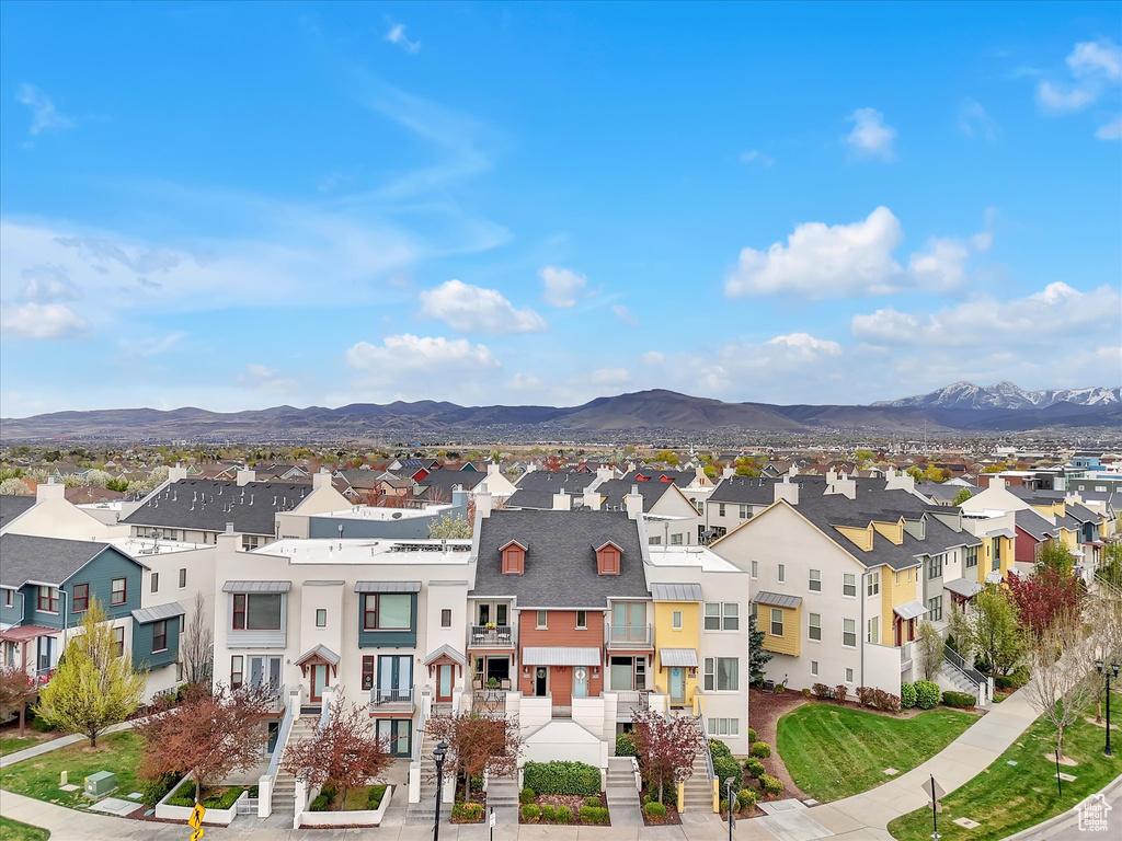View of property featuring stairs, a mountain view, and a residential view