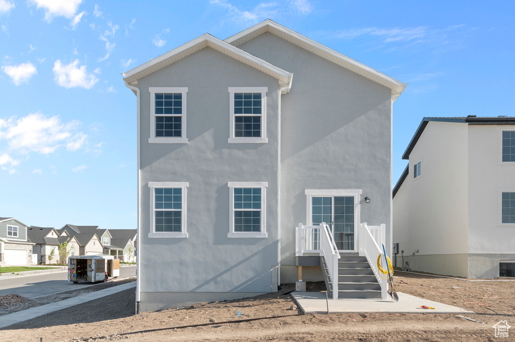 View of front of house with stucco siding and a residential view