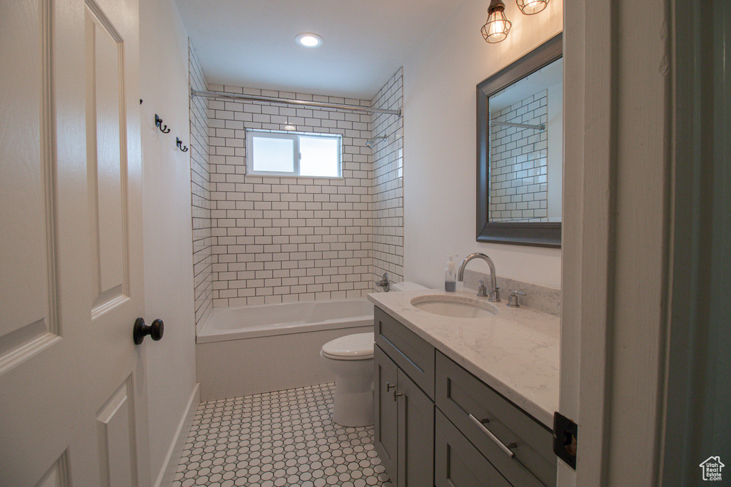 Full bathroom featuring vanity, recessed lighting, shower / tub combination, and toilet