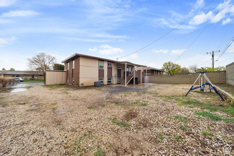 Rear view of property featuring fence