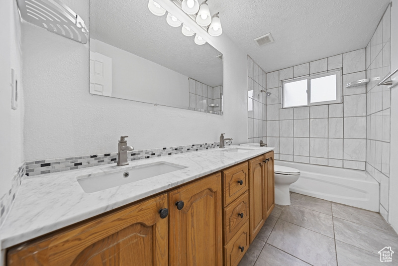 Bathroom with tile patterned flooring, visible vents, a sink, and toilet