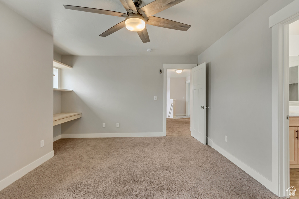 Interior space featuring ceiling fan and baseboards