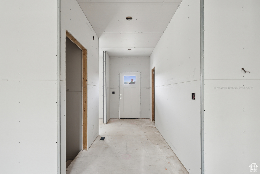 Hall with unfinished concrete flooring