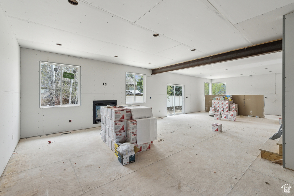 Unfurnished living room featuring a glass covered fireplace