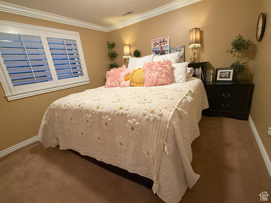 Bedroom featuring carpet flooring, baseboards, and ornamental molding