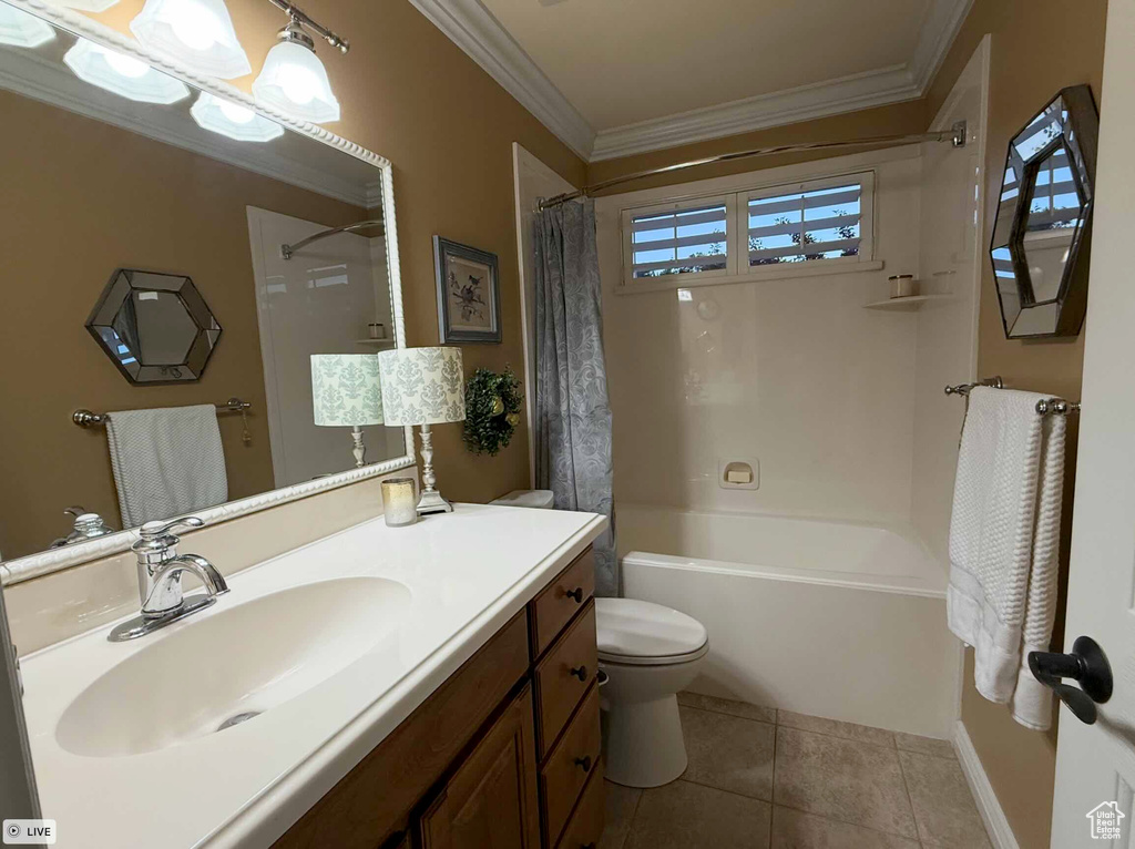Bathroom with toilet, vanity, shower / bathtub combination with curtain, ornamental molding, and tile patterned flooring