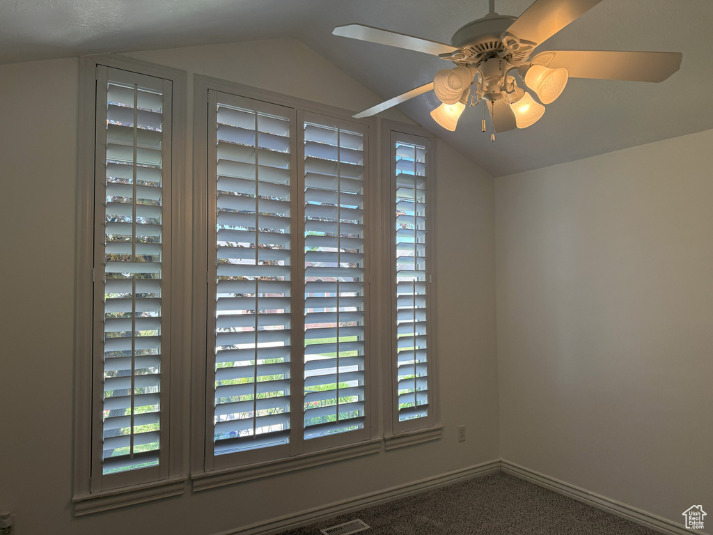 Detailed view of carpet floors and a ceiling fan