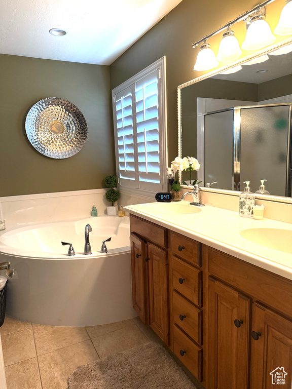 Full bath featuring a shower stall, double vanity, a bath, and tile patterned floors