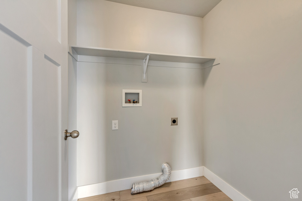 Clothes washing area featuring laundry area, wood finished floors, baseboards, electric dryer hookup, and washer hookup