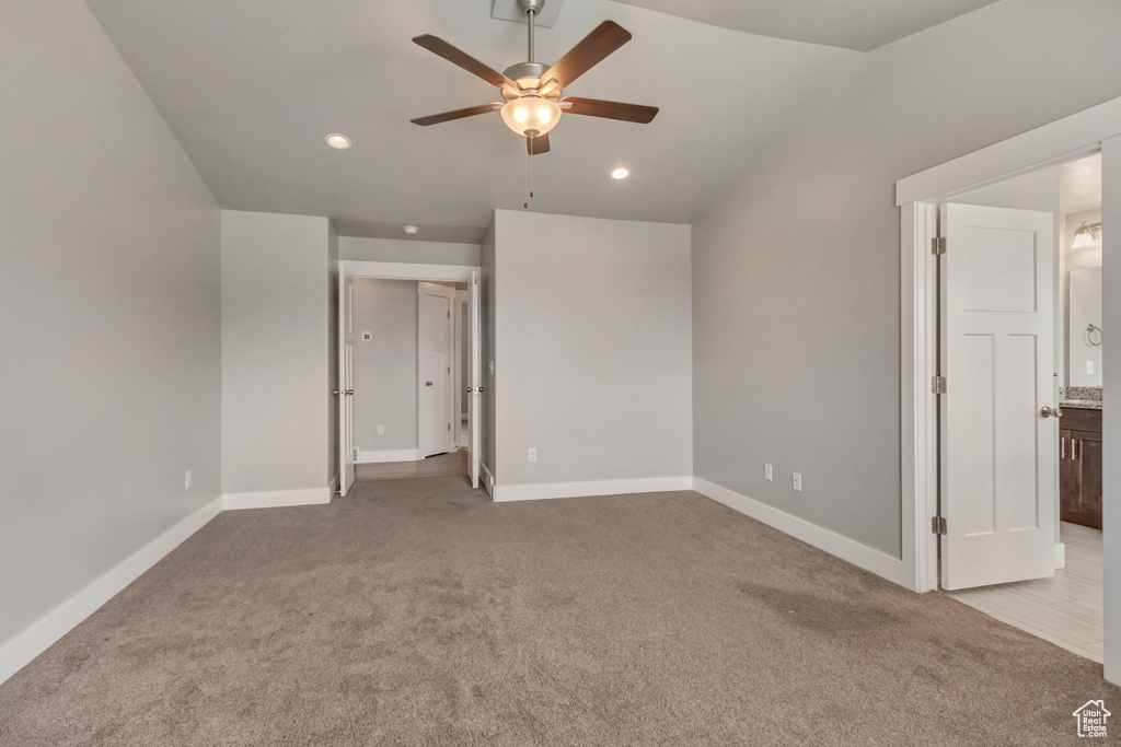 Unfurnished bedroom featuring recessed lighting, baseboards, lofted ceiling, and light colored carpet